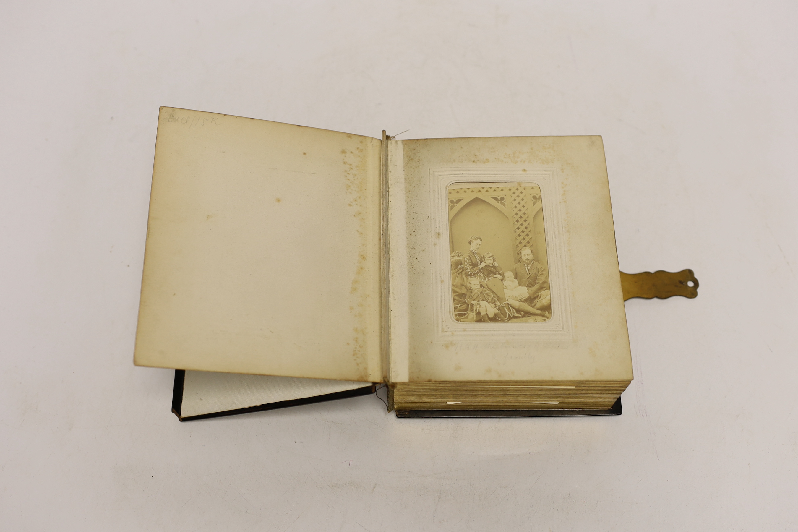 A Russian lacquer boarded photograph album, Lukutin, late 19th century, decorated with a couple and child, containing Victorian photographs, 16 cm x 13.5cm, Please note this lot attracts an additional import tax of 5% on